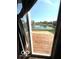 Picture window view featuring a patio, serene pond, and lush greenery at 7659 Misty Meadow Dr, Indianapolis, IN 46217