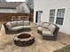 Backyard with a patio, sofas, fire pit, dining table, chairs, and home at 8048 Garden Ridge Rd, Indianapolis, IN 46237
