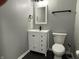 A compact bathroom features a new white vanity, neutral walls, and modern fixtures at 8048 Garden Ridge Rd, Indianapolis, IN 46237