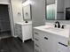 This bathroom features dual sinks with quartz countertops, white cabinets, and dark hardware at 8048 Garden Ridge Rd, Indianapolis, IN 46237