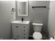 Modern bathroom featuring a vanity, mirror, black fixtures and a toilet with a dark-colored floor at 8048 Garden Ridge Rd, Indianapolis, IN 46237