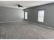 A large bedroom offers ample space, soft carpet, and natural light from two windows at 8048 Garden Ridge Rd, Indianapolis, IN 46237