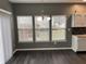 This dining area has dark floors, natural light, and modern light fixtures at 8048 Garden Ridge Rd, Indianapolis, IN 46237