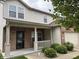 Charming two-story home with a brick facade, covered porch, and well-maintained landscaping at 8048 Garden Ridge Rd, Indianapolis, IN 46237