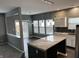 Open-concept kitchen with island, stainless steel appliances, white cabinets, and adjacent dining area at 8048 Garden Ridge Rd, Indianapolis, IN 46237