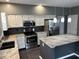 Stylish kitchen with white cabinetry, granite countertops, stainless steel appliances, and center island with bar seating at 8048 Garden Ridge Rd, Indianapolis, IN 46237