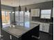 An open kitchen features a large island with granite countertop and modern fixtures at 8048 Garden Ridge Rd, Indianapolis, IN 46237