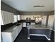 Modern kitchen with an island, granite countertops, stainless steel appliances and dark backsplash at 8048 Garden Ridge Rd, Indianapolis, IN 46237