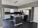Spacious kitchen with stainless steel appliances, modern lighting, and dark hardwood floors at 8048 Garden Ridge Rd, Indianapolis, IN 46237