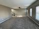 Bright and airy living room featuring gray walls, carpeted floor, and natural light from the windows at 8048 Garden Ridge Rd, Indianapolis, IN 46237