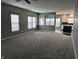 Spacious living room with plenty of natural light and gray paint, seamlessly connected to the dining and kitchen areas at 8048 Garden Ridge Rd, Indianapolis, IN 46237