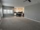 Open concept living room and kitchen with neutral color palette, carpeted floors, and ample natural light at 8048 Garden Ridge Rd, Indianapolis, IN 46237