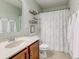 Bathroom with a white patterned shower curtain, a single sink vanity, and a mirror on the wall at 8218 Elsen Ridge, Avon, IN 46123