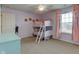 Well-lit bedroom featuring bunk beds, a window with pink curtains, and a light blue dresser at 8218 Elsen Ridge, Avon, IN 46123
