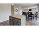 Open concept dining room area with a wood table, black chairs, and views of the Gathering room at 8218 Elsen Ridge, Avon, IN 46123