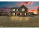 Stunning two-story brick home with a welcoming front porch and beautiful sunset view at 8218 Elsen Ridge, Avon, IN 46123