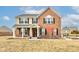 Charming two-story brick and siding home with a covered porch and manicured front yard at 8218 Elsen Ridge, Avon, IN 46123