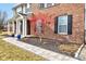Close-up of the front exterior with landscaping and front porch seating at 8218 Elsen Ridge, Avon, IN 46123