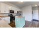 Bright kitchen featuring stainless steel appliances, white cabinets, and a center island on hardwood floors at 8218 Elsen Ridge, Avon, IN 46123