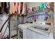 Laundry room with white washer and dryer, storage shelves, and utility sink at 8218 Elsen Ridge, Avon, IN 46123