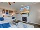 Living room features a fireplace, a large screen TV, hardwood floors, and a comfortable sectional sofa at 8218 Elsen Ridge, Avon, IN 46123