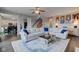Bright living room with open concept and hardwood floors features a large sectional sofa and easy access to the kitchen at 8218 Elsen Ridge, Avon, IN 46123