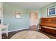 Home office leading to a hallway and showcasing an antique piano and stylish decor at 8218 Elsen Ridge, Avon, IN 46123