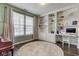 Home office featuring custom built-in shelving, a work area, and a round area rug at 8218 Elsen Ridge, Avon, IN 46123