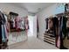 Organized walk-in closet with shelving and hanging racks for efficient storage solutions at 8218 Elsen Ridge, Avon, IN 46123