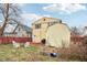A cozy backyard featuring a fire pit, seating area, and a storage shed at 854 W Roache St, Indianapolis, IN 46208