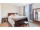Bedroom featuring a dark wood bed frame, matching bedside table and mirror at 854 W Roache St, Indianapolis, IN 46208