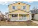 Charming yellow two-story home with a welcoming front porch and white trim at 854 W Roache St, Indianapolis, IN 46208
