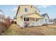 Charming two-story home with a welcoming front porch and yellow siding at 854 W Roache St, Indianapolis, IN 46208