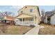 Charming two-story home with a welcoming front porch and yellow siding at 854 W Roache St, Indianapolis, IN 46208
