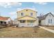 Charming two-story home with a welcoming front porch and yellow siding at 854 W Roache St, Indianapolis, IN 46208