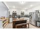 Modern kitchen with stainless steel appliances, granite countertops, and a wooden center island at 854 W Roache St, Indianapolis, IN 46208