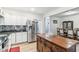 Bright kitchen with stainless steel appliances, island and breakfast bar seating at 854 W Roache St, Indianapolis, IN 46208