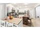 Bright kitchen with stainless steel appliances, mosaic backsplash, wooden island, and white cabinets at 854 W Roache St, Indianapolis, IN 46208
