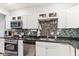 Well-equipped kitchen with stainless steel appliances, stylish backsplash, and ample counter space at 854 W Roache St, Indianapolis, IN 46208