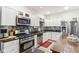 Modern kitchen with stainless steel appliances, granite countertops, and white cabinets at 854 W Roache St, Indianapolis, IN 46208