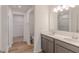 Bathroom with double sinks, modern cabinets, and glimpse into walk-in closet at 9345 Anthem Ave, Plainfield, IN 46168