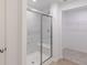 Modern bathroom featuring a glass-enclosed shower with marble-patterned tile and a built-in seat at 9345 Anthem Ave, Plainfield, IN 46168