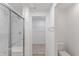 Bathroom featuring a glass-enclosed shower, toilet, and a glimpse into the walk-in closet at 9345 Anthem Ave, Plainfield, IN 46168