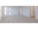 Bright bedroom with plush carpet, white walls, and doorway to bathroom with a glass shower door at 9345 Anthem Ave, Plainfield, IN 46168