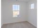 Bright bedroom featuring neutral carpet, white trim, and double window letting in natural light at 9345 Anthem Ave, Plainfield, IN 46168