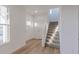 Bright entryway with wood-look floors, white walls and trim, and a carpeted staircase at 9345 Anthem Ave, Plainfield, IN 46168