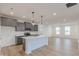 Modern kitchen with gray cabinetry, stainless appliances, and a large island at 9345 Anthem Ave, Plainfield, IN 46168
