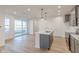 Modern kitchen with large island, sliding glass doors, and stainless steel appliances at 9345 Anthem Ave, Plainfield, IN 46168