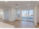 Bright, open-concept living room with light hardwood floors and sliding glass doors to outdoor space at 9345 Anthem Ave, Plainfield, IN 46168