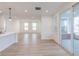 Spacious living room featuring light hardwood floors, an open layout, and large windows at 9345 Anthem Ave, Plainfield, IN 46168